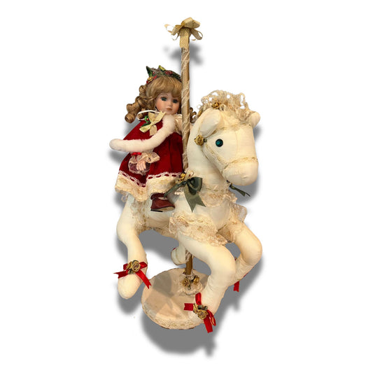 Christmas porcelain doll riding a carousel horse